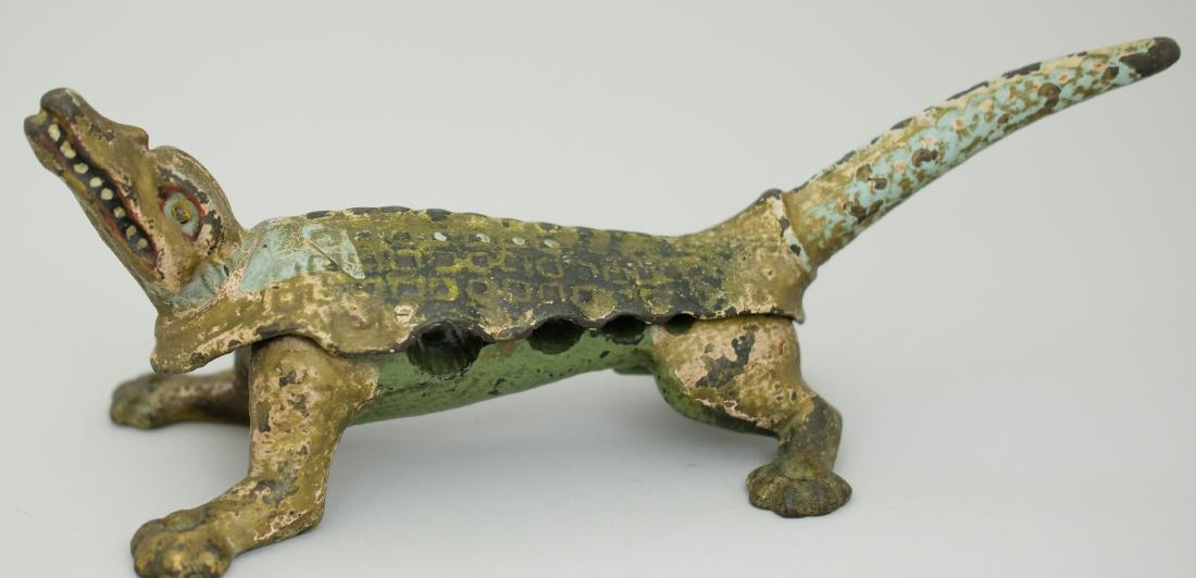 Alligator Masher: American - Circa 1900's - 11.5" L This kitchen utility and; used for mashing and crushing. Each leg with a hole so he could be secured to the counter. Cast Iron