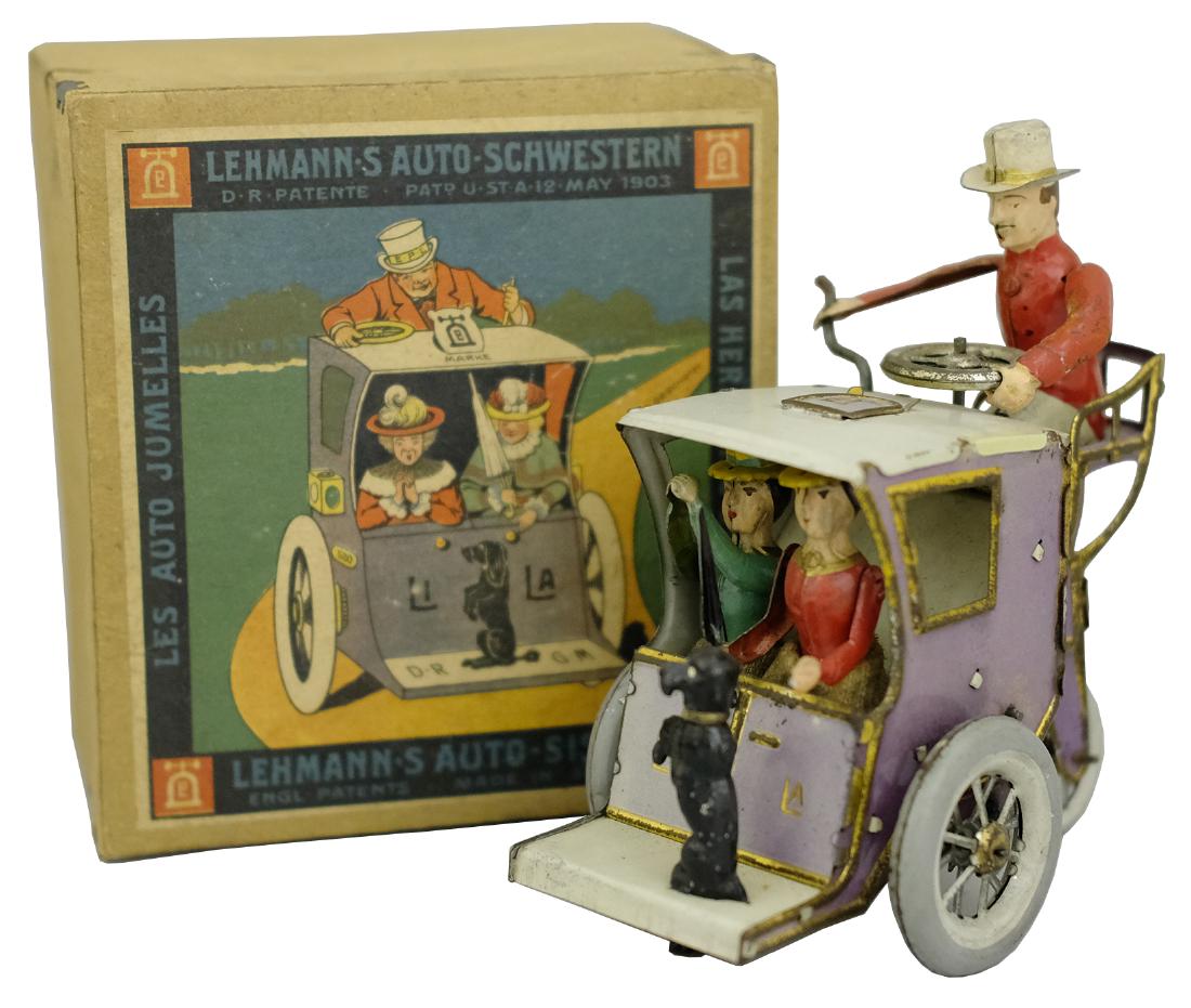 “Li - La” (EPL No. 520) • Lehmann’s Auto Sisters •: ; Production Run: 1900-33. Ernst Paul Lehmann drew this design based upon the actual motorized hansom cabs that he had seen in the streets of London. The driver sits behind the passengers. One lady ra