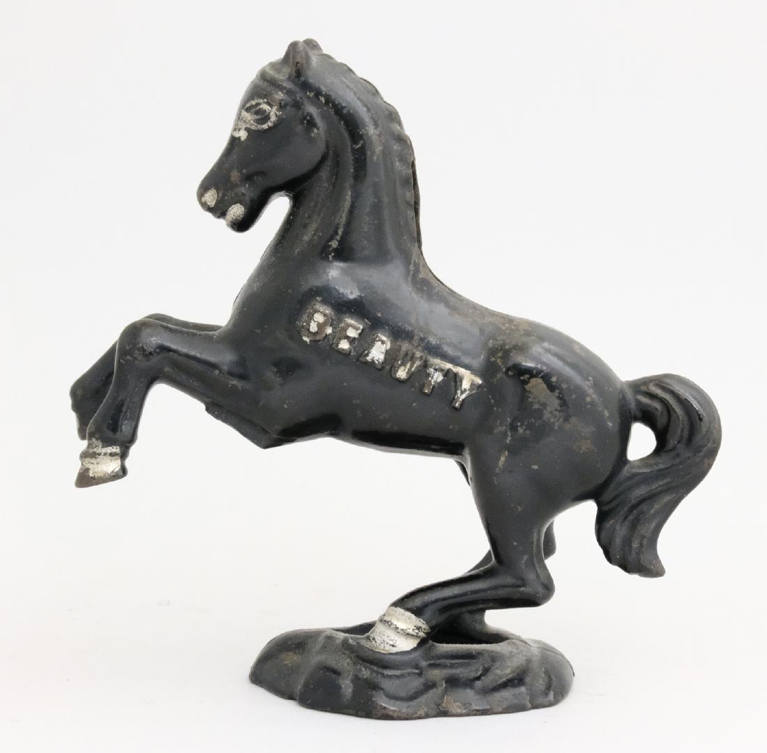 "Beauty" on Oval base: A. C. Williams Ravenna, OH - 1920's This is a scarce bank in wonderful condition. Material: Cast Iron