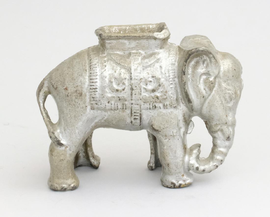 Elephant with Howdah - Tiny, Silver: A. C. Williams Ravenna, OH - 1920's Material: Cast Iron