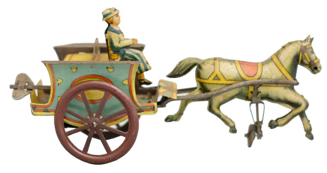Woman Riding a Gig: Probably G & K Germany - Circa 1920's - 7" L The toy works very well. Material: Tin