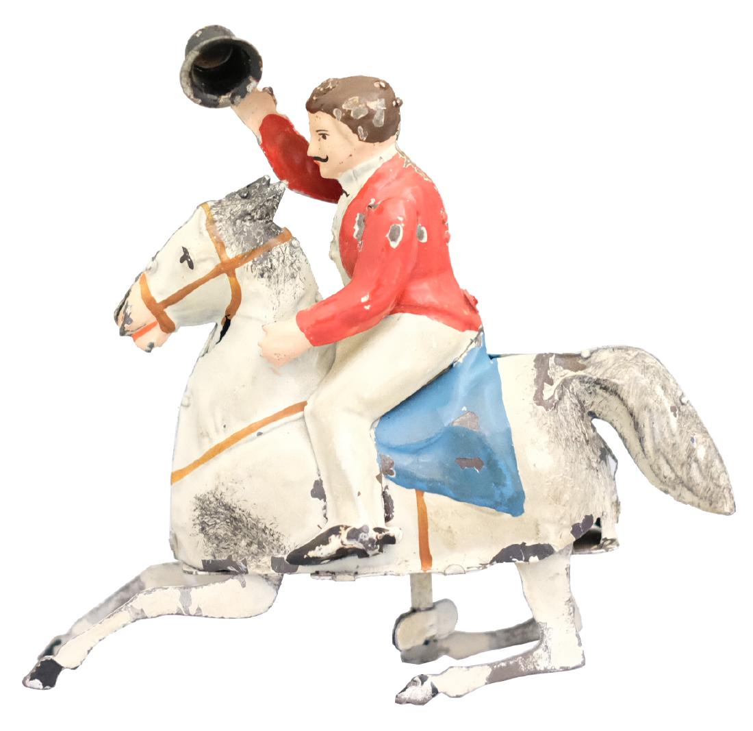 Ringmaster on Horseback: S.G. Gunthermann Germany - Circa 1915 - 5" T This is a superior example of this early hand-painted toy. It works very well. Material: Tin