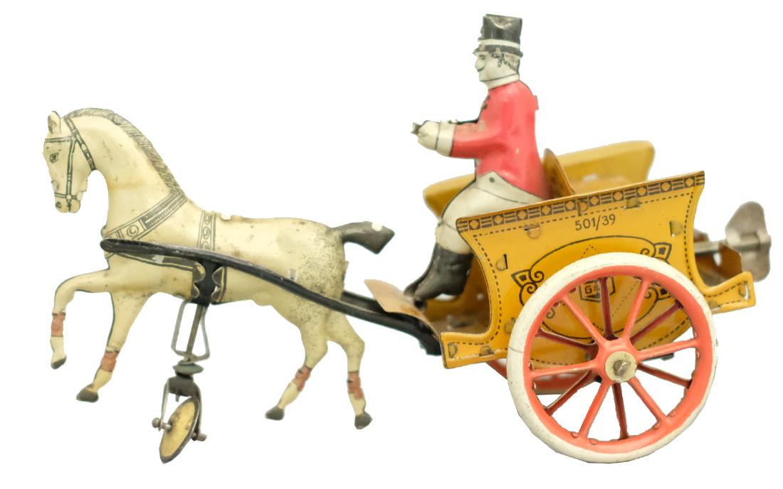 Ringmaster Riding a Gig: G & K Germany - Circa 1920's - 7" L This colorful and bright toy works well. Material: Tin