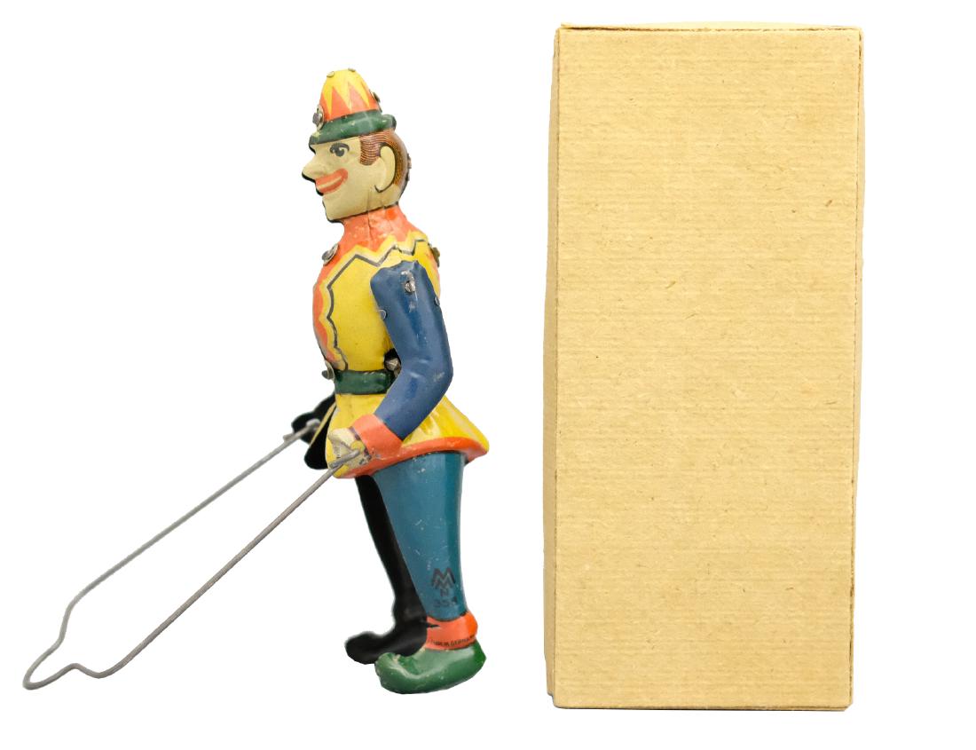 Hanging Acrobat: Morris Moskowitz Germany - Circa 1920's - 5.75" T Mint in box. This toy works extremely well. The toy tumbles after being wound. Going through, around and back around the wire hanging frame. Material: