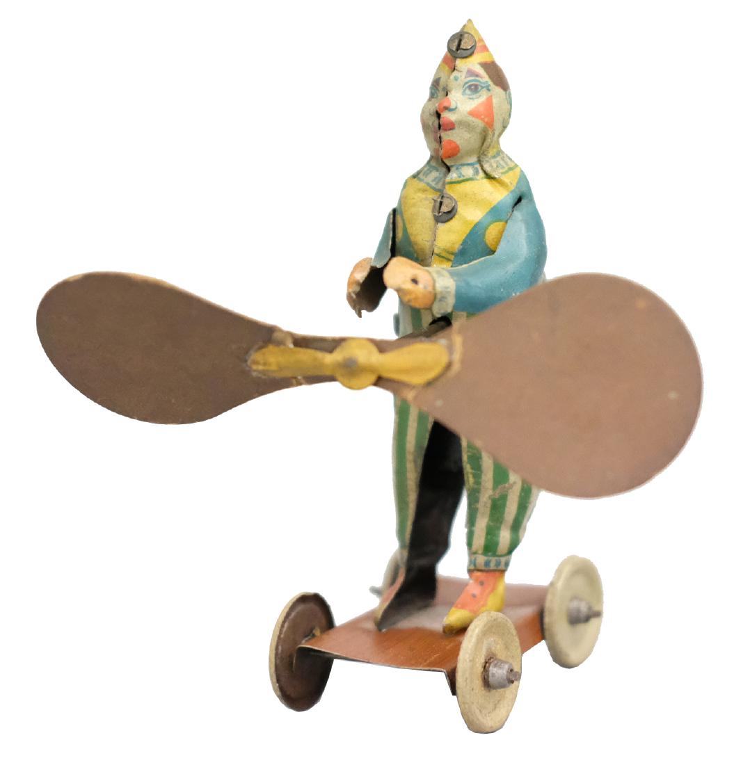 Clown on Platform: Probably CKO Germany - Circa 1920's - 6" T The spinning fan propels him forward. The toy works exceedingly well. Material: Tin