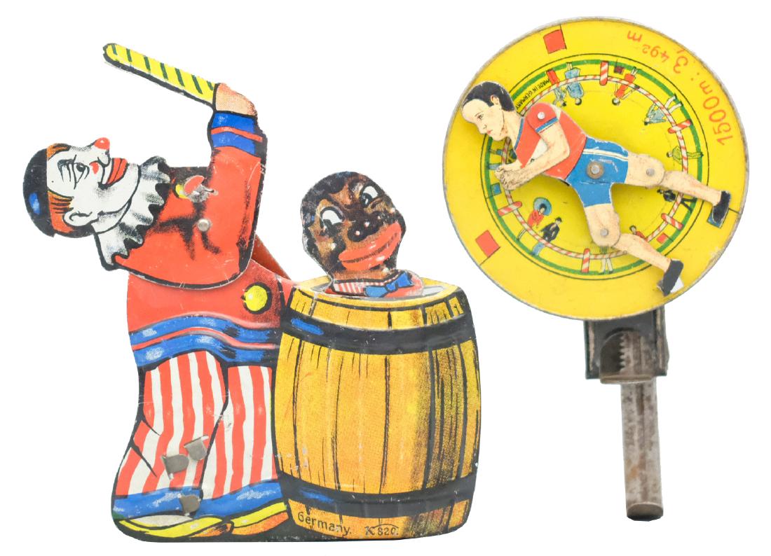 Two Hand Operated Tin Toys: German - Circa 1920's/30's - 5" T The running figure symbolizes Jules Ladoumegue when he set the world record for 1500m in Paris, France in 1930. Material: Tin