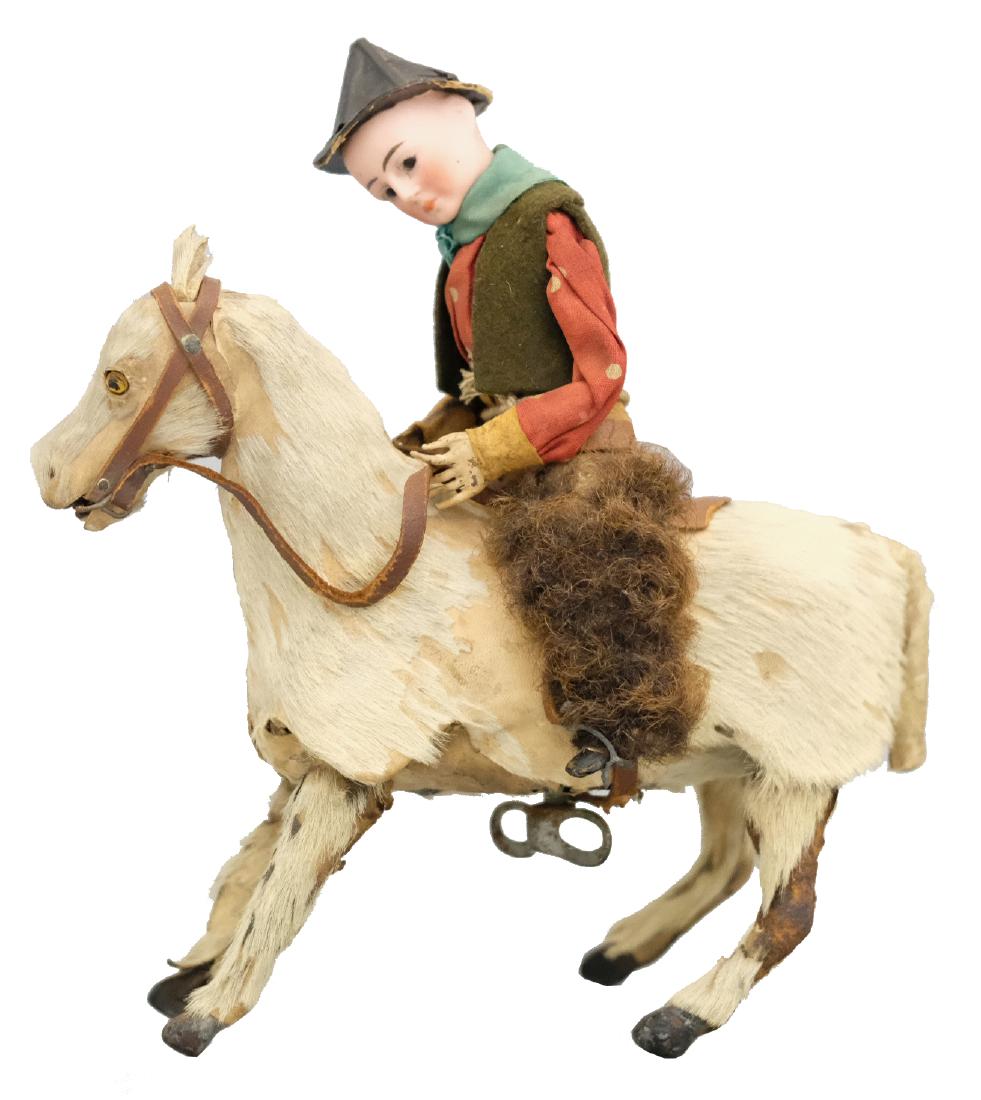 Cowboy on Horseback: French - Circa 1895 - 8" L This windup toy depicts a French cowboy in furry chaps. It works very well. Material: Genuine hide, horsehair, felt and bisque