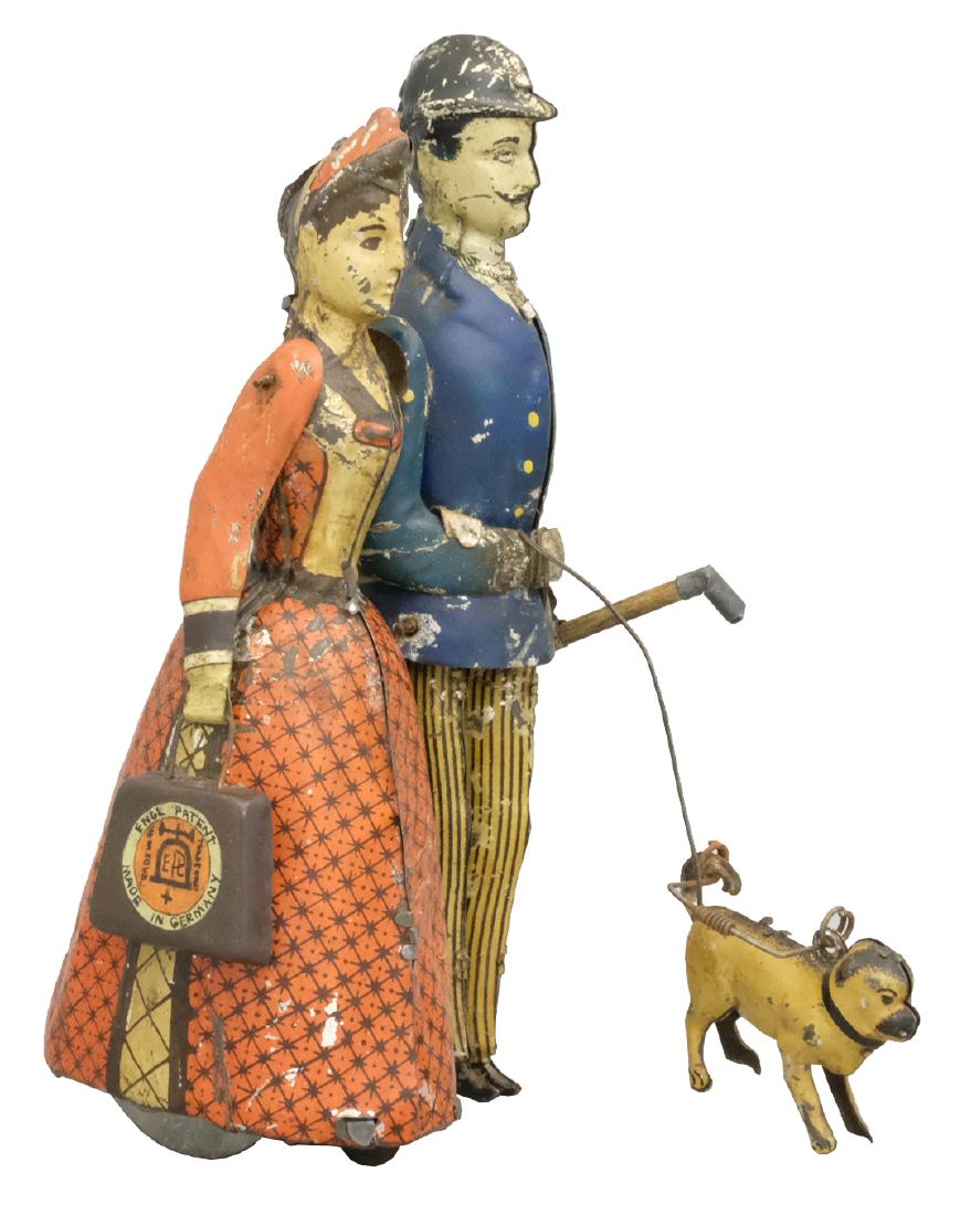 "Walking Down Broadway" Known as the Lehmann Family: Production Run: 1890-1895 Erns Paul Lehmann immortalized himself and his wife Martha in this charming tin toy. To set the toy in motion, one must carefully draw a toothed rack rapidly across the perfo