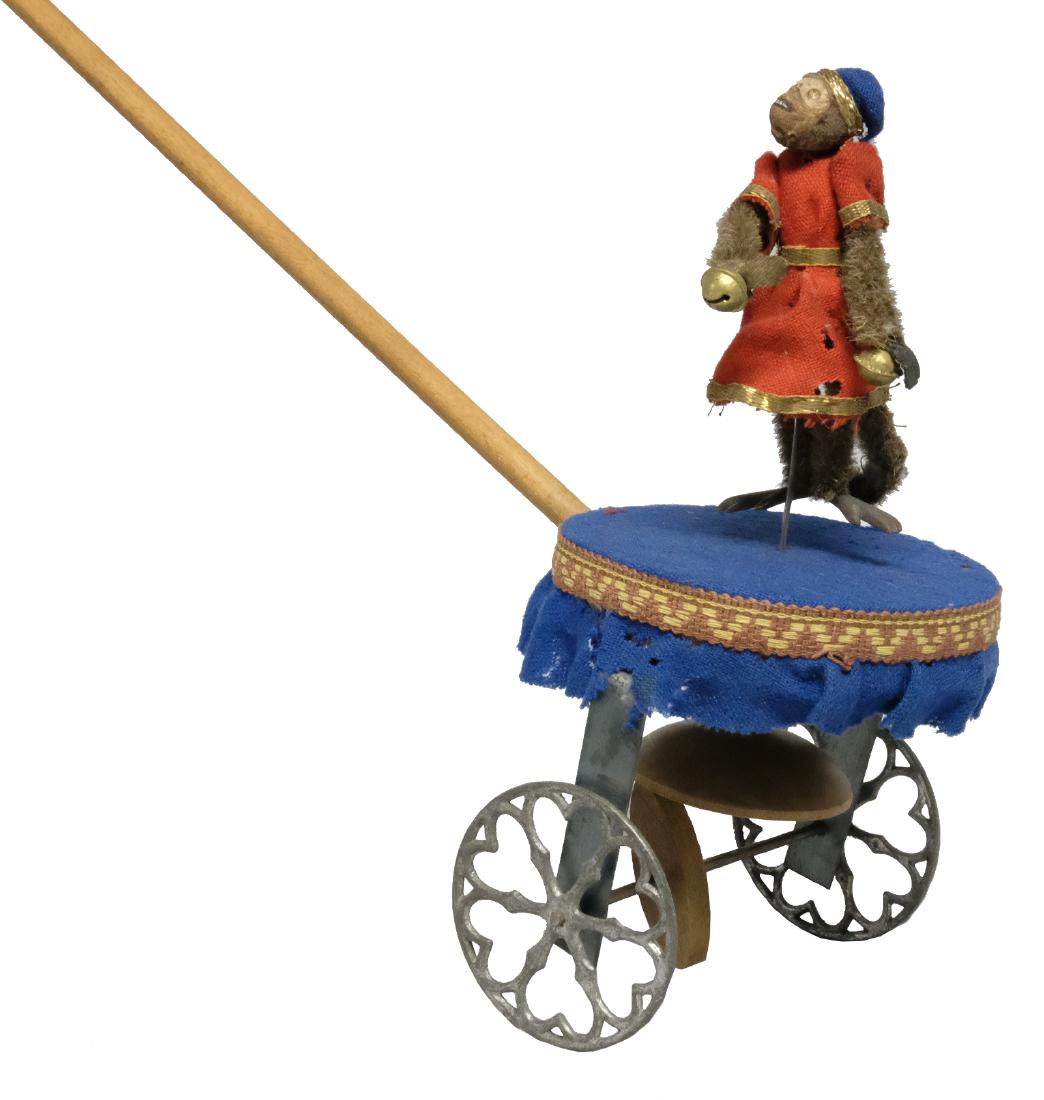 Missing Link on Circular Base: Ives, Blakeslee & Company Bridgeport, CT - Circa 1880's This is a very scarce hand propelled toy. As the stick toy is pushed the monkey dances wildly on the circular base. Material: Wood & fabric