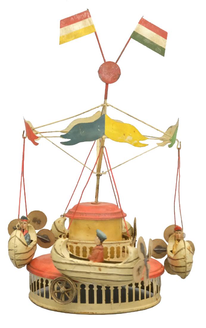 Canoe Ship Go Round: Mueller & Kadaderer German - Circa 1910 - 13.5" T This classic toy works well, but is substantially restored. Material: Tin and cardboard