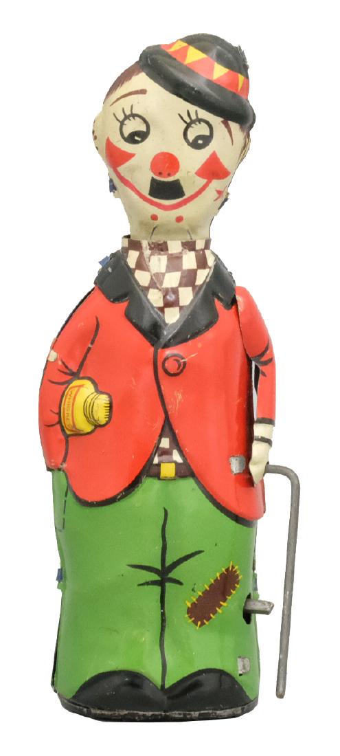 Charlie Chaplin: Marked Fairylis Probably German - Circa 1930's - 6" T A graphic toy whose head goes up and down and the cane twirls. Material: Tin