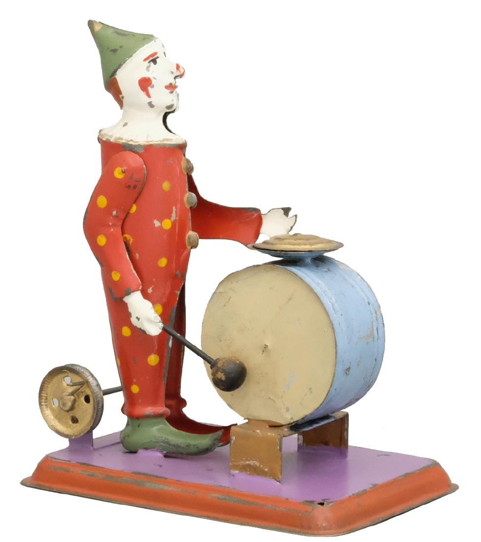 Clown Drummer: German - Circa 1920's - 6.25" T This toy can be used either as a hand crank or steam attachment. Material: Tin