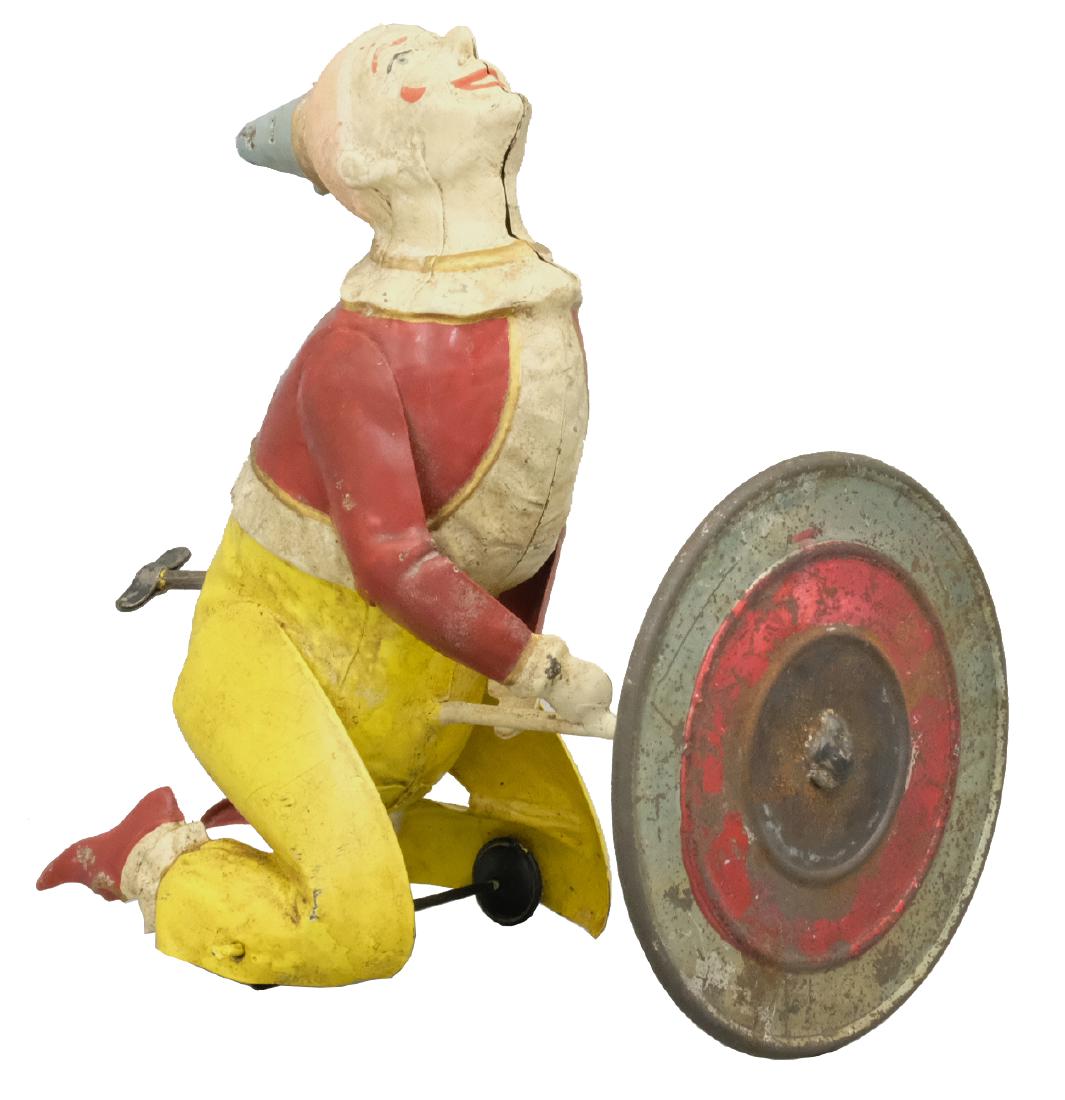 Clown Go Round: S.G. Gunthermann German - Circa 1910's - 6" T When wound, this toy spins around with the use of its umbrella. Material: Tin