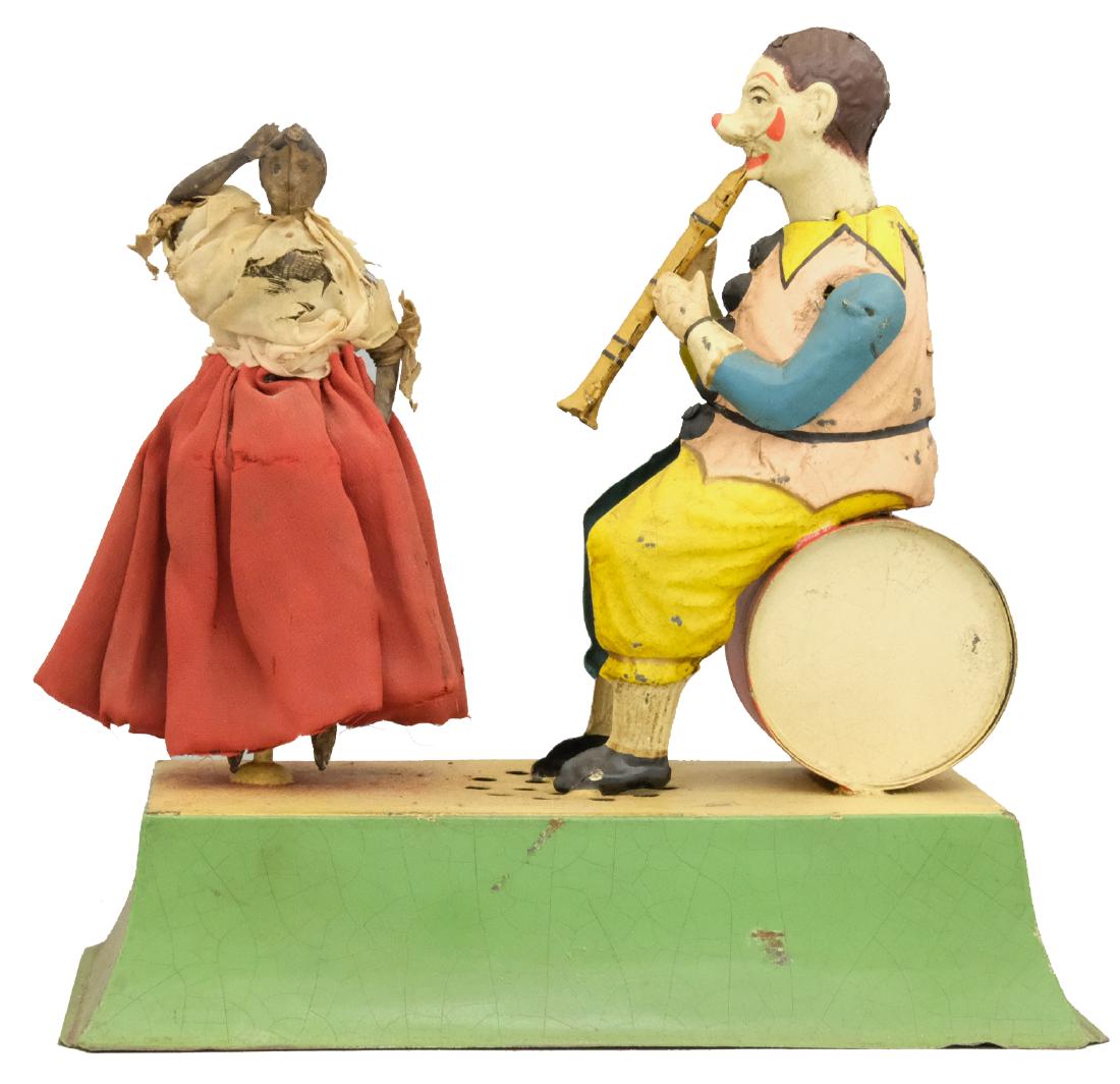 Clown Musician and Dancing Girl: S.G. Gunthermann German - Circa 1910's - 8.75" L The clown raises his arms as if playing the clarinet as the young girl spins around. Material: Tin and fabric
