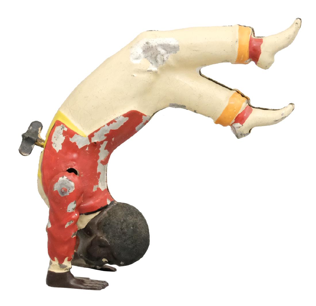 Black Gymnast: S.G. Gunthermann German - 1910's - 5.75" T This hand painted German windup is a little gem. Material: Tin