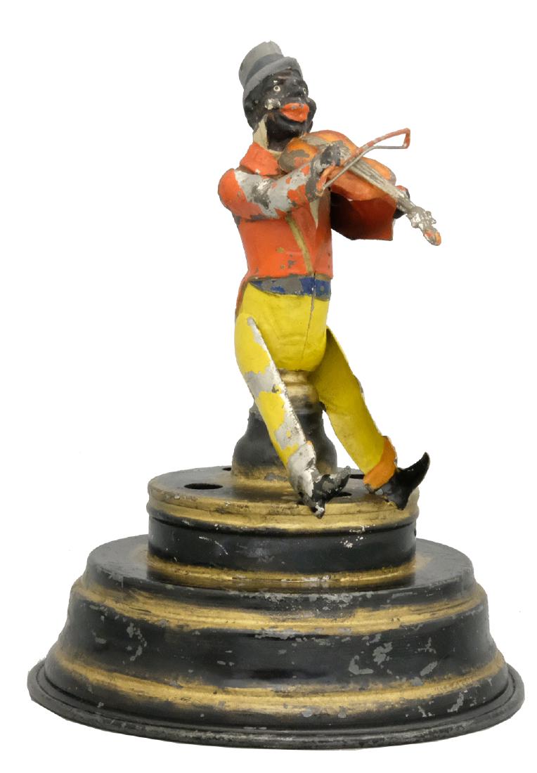 Black Violinist on Base: S.G. Gunthermann German 1910's - 7.75" T This is a Superior and Bright condition example of the toy. He plays his violin and music is played. A show stopper. Material: Tin