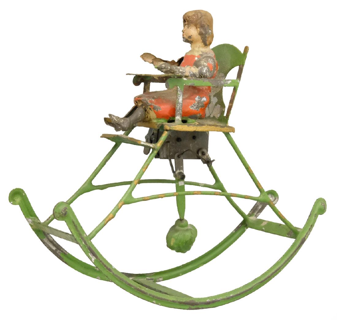 Toddler in Rocking Chair: German - Circa 1910's - 6.75" L Material: Tin