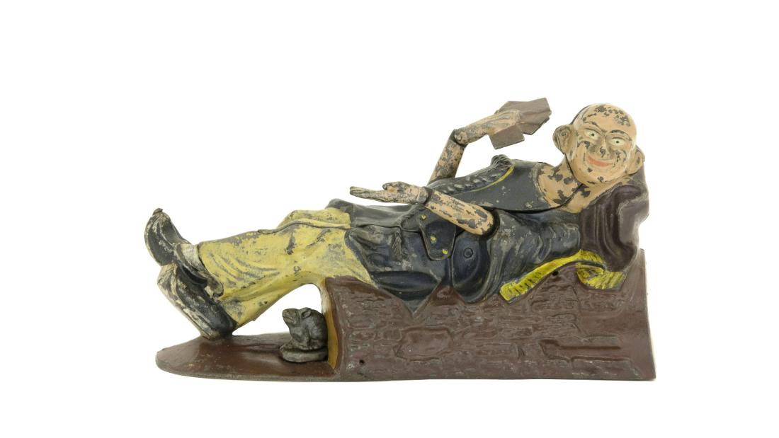 Reclining Chinaman: J. & E. Stevens Cromwell, CT - 1880's Cast Iron Pennies placed in his jacket pocket disappear when you press the lever. At the same time, he lowers his right hand to reveal four aces from up his sleev