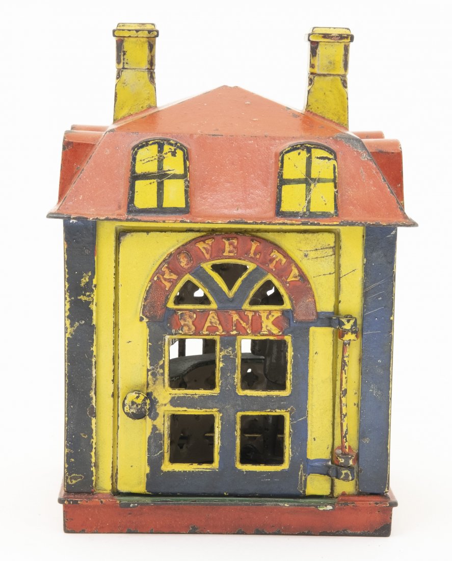 Novelty - Yellow Iron Bank: J. & E. Stevens. Cromwell, CT - 1873. Open the door and place a coin on the tray. A tap to the open door will cause it to snap shut quickly and deposit the coin into the bank. Cast Iron. Very Fine Con
