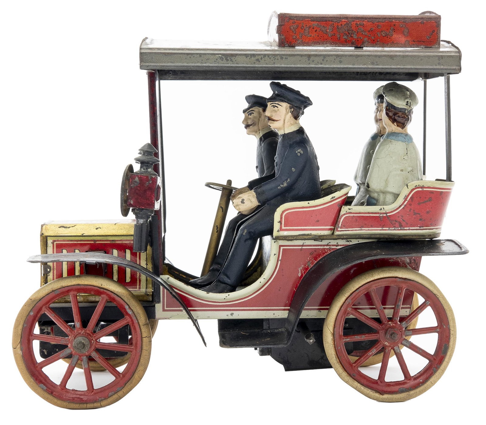 Carette No. 50 Auto: German, Circa 1912, 8.5" L This toy is seldom seen with all four original figures and both original headlights. Possibly new Right fender. Windshield supports retained.