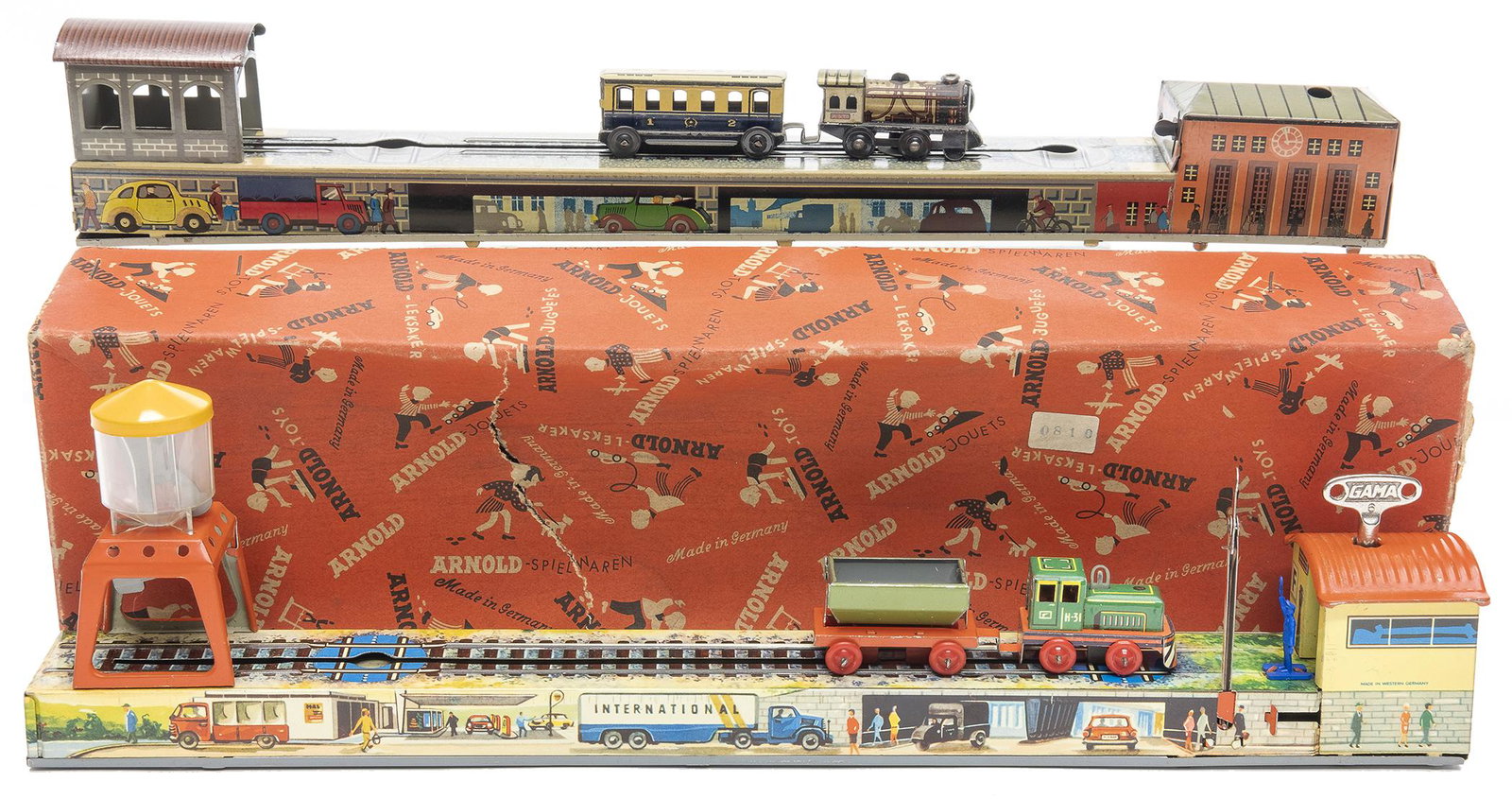 Two Arnold Back and Forth Trains: German, 1950, 15" L One in its original box depicts the transport of grain from silo to loading dock.