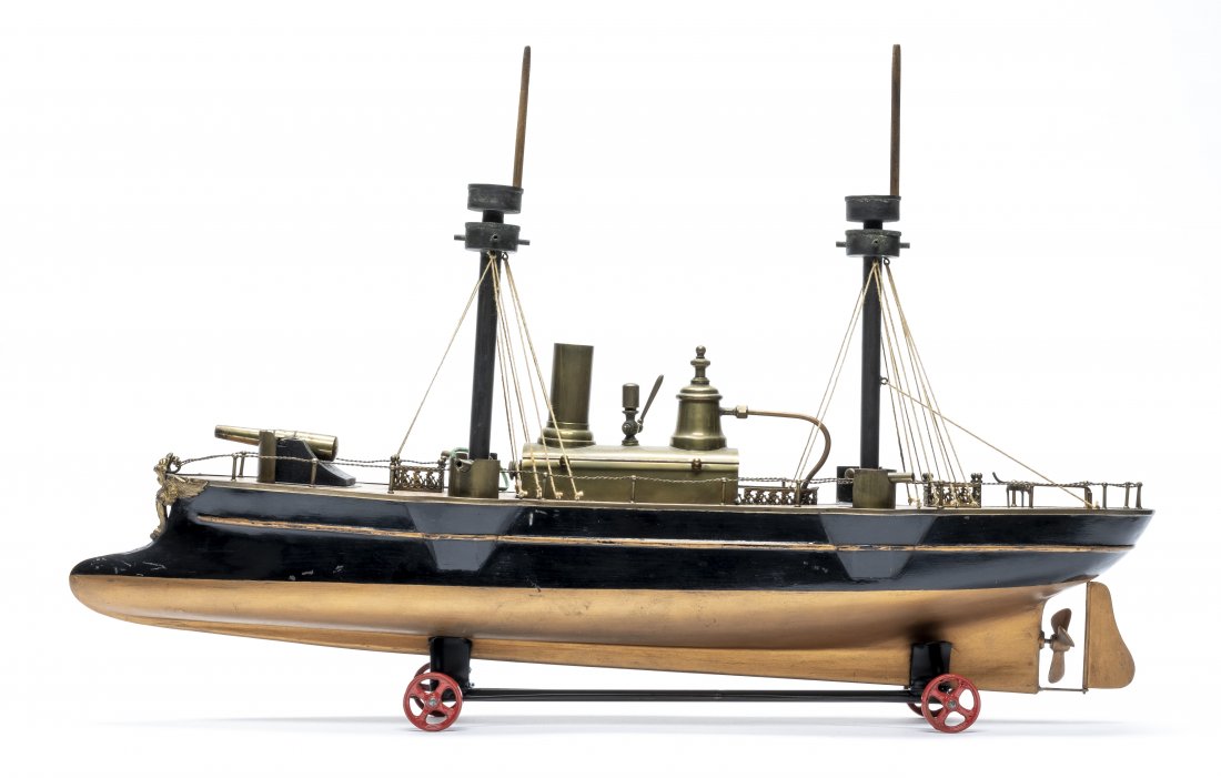 Radiguet Gun Boat: French - 1880 - 22" L This is a classic Radiguet boat; made of tin, brass and wood. Painted black and copper. All parts are original except the carrier supporting it. A great addition to any collectio