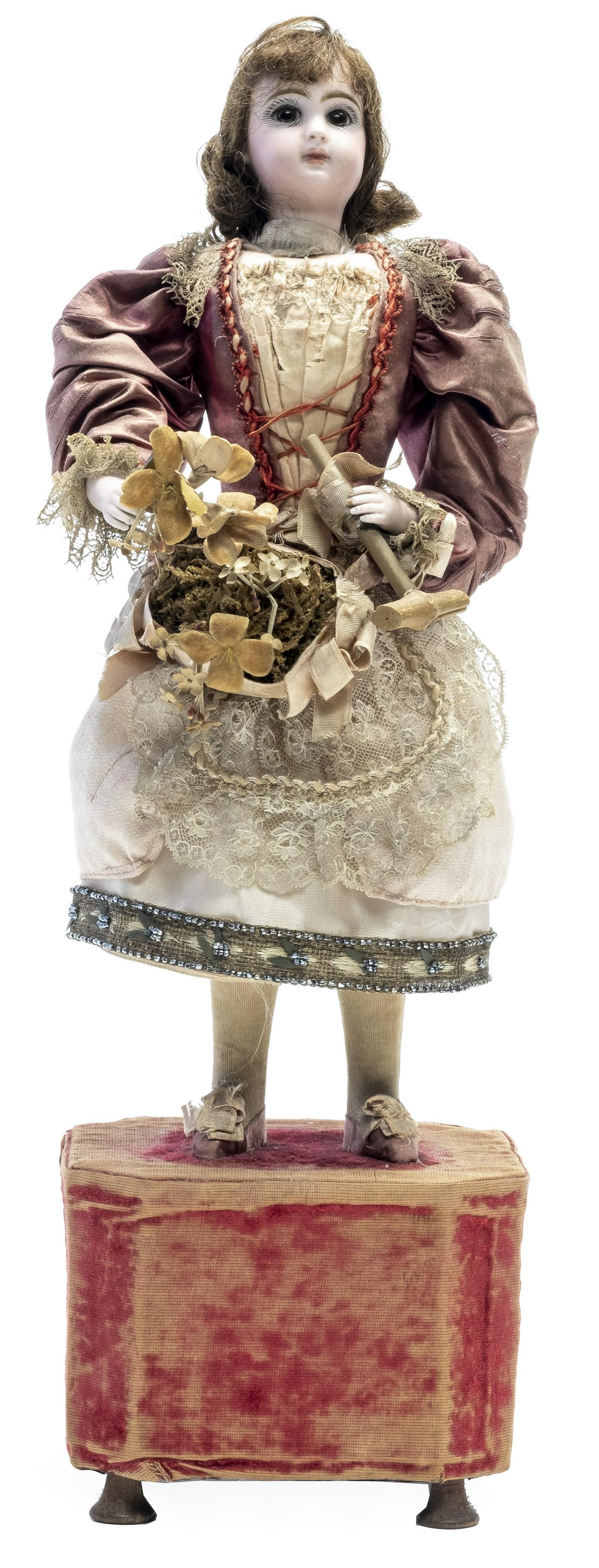 Girl with Bouquet & Parasol Automaton: Probably by Leopold Lambert French - 1880's - 19 1/2" Tall Excellent (Lacks Upper Parasol) This pretty lass is blossoming with the pulchritude of youth. She wears an attractive costume and she seems d