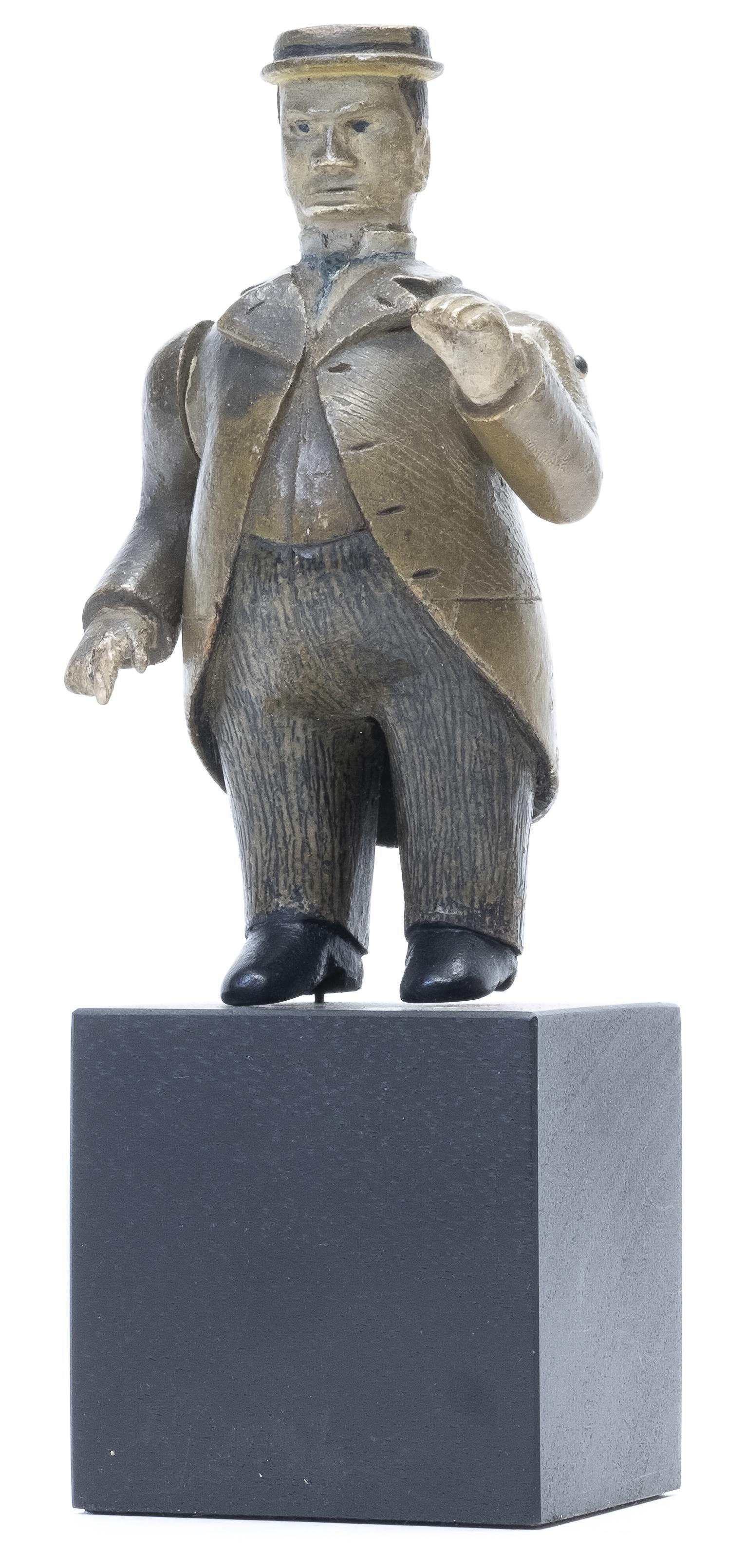 Folk Art Carving of a Rotund Man: Presented on a Modern Base New England - 1890 - 5 1/2" Tall Outstanding Quality & Great Patina Though small in scale. 1/4" of the tips of shoes are replaced. This jaunty fat man has a surprisingly lar