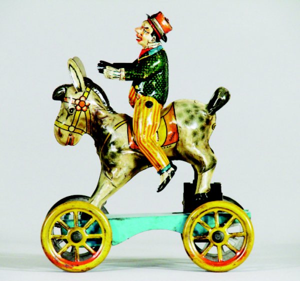 Man Riding Donkey: Made by Gama • German, Circa 1940 We believe this to be a scarce toy with self winding mechanism. Toy is 6 ½" inches long. Material: Tin Condition: Excellent