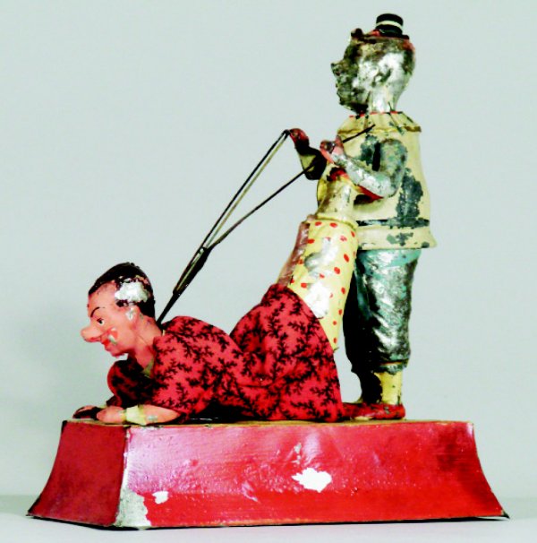 Guntermann Clowns Windup Toy: German – Circa 1915 A great toy depicting two clowns. One clown is being used as a human cello. The toy works well and is 10" tall by 8" long. Material: Tin and Fabric Condition: Overall Very Good, 