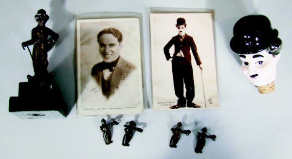 Lot: Charlie Chaplin Memorabilia: German – Circa 1920's, 1930'sThe lot includes 2 post cards, 4 brass pins, statue and porcelain bottle stopper. Condition: Very Fine