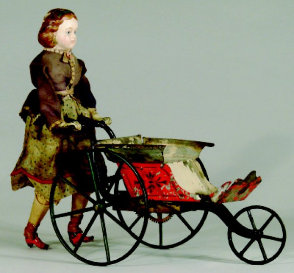 Goodwin Patent Girl with Pram: Made by Stevens and Brown • Connecticut, Circa 1875 A classic toy made by Stevens & Brown. Slightly scarce with tin bodied pram. Provenance: Perelman Toy Museum Condition: Fine