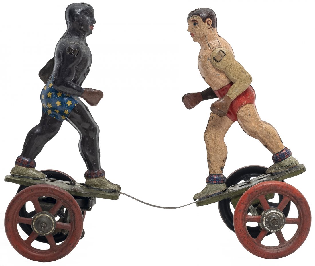 Windup Boxing Toy on Wheels: Made by Einfalt German - 1920's - 7.5" L Very Fine Condition This toy goes back and forth as the momentum causes the boxers arms to throw punches. Probably based upon the Max Schmeling - Joe Louis fig