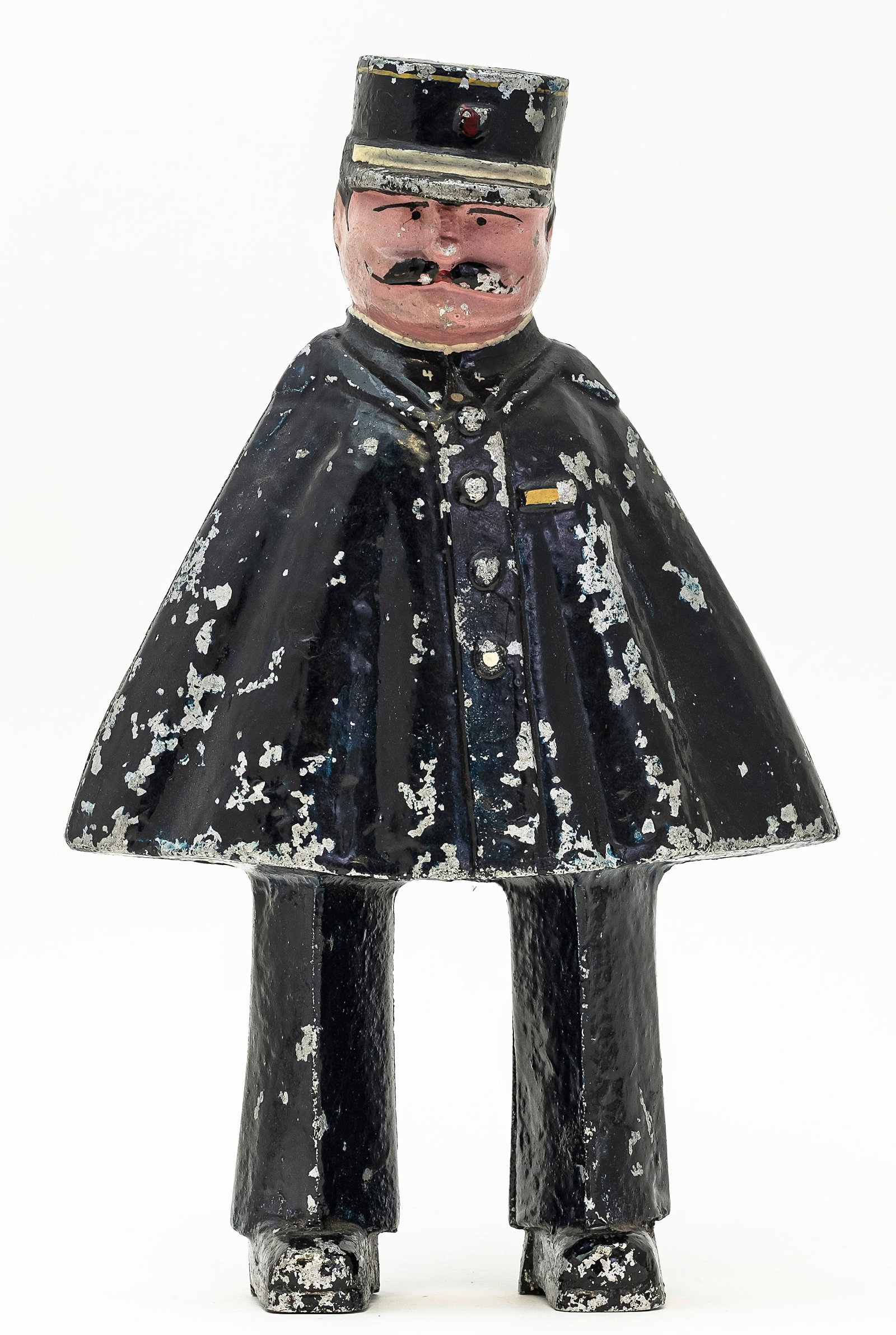 The French Gendarme Bank: Rare Aluminum Bank. Probably Circa Late 1930's. The minimal abstract silhouette formed by the policeman's legs jutting out from the bottom of his large sweeping cape makes for a genuinely sculptural t