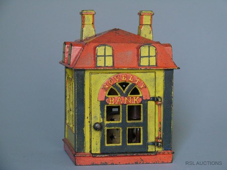 Novelty Bank – yellow and Red Mechanical Bank: Made by the J. & E. Stevens Company Cromwell, Connecticut – Circa 1873 Open the door and place a coin on the tray. A tap to the open door will cause it to snap shut quickly and deposit the coin into