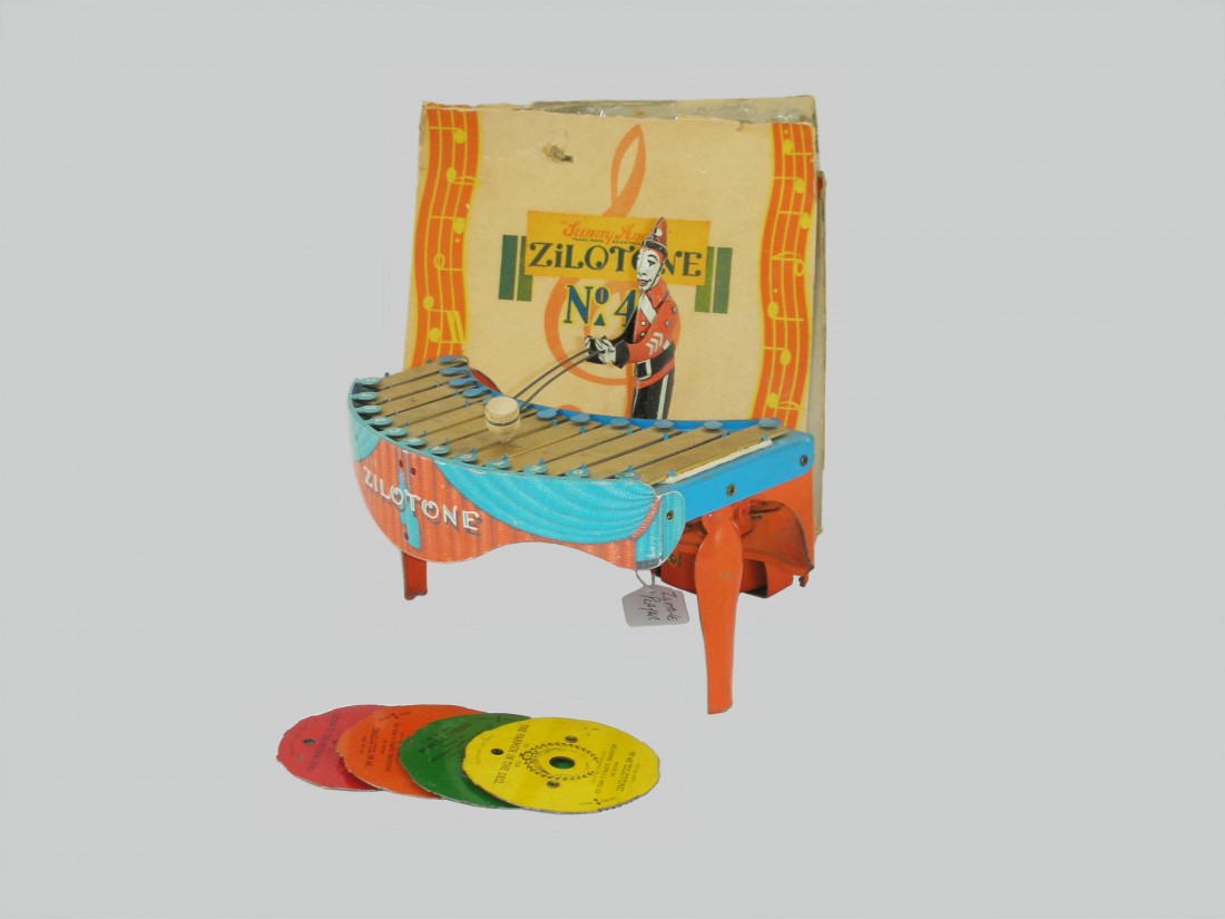 Zilotone: Zilotone -Made by Wolverine Mfg. Pittsburgh, Pennsylvania - Circa 1930 A terrific musical toy, retaining all four original musical discs. Insert one and the clown plays a tune. Has it's extremely rare