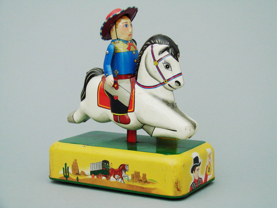 Galloping Cowboy: Galloping Cowboy -Made by Cragstan Toy Company Japanese – Circa 1950 An extremely scarce, battery operated mechanical bank. It depicts a cowboy riding the Oregon Trail to the far west. Material: Lit