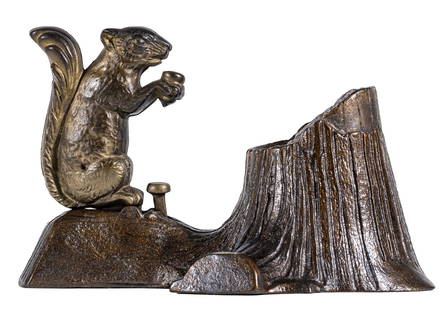 Squirrel and Tree Stump Iron Mechanical Bank: Made by Mechanical Novelty Works. New Britain, Ct. - 1880's. A clever squirrel hides his surplus acorns when times are good.