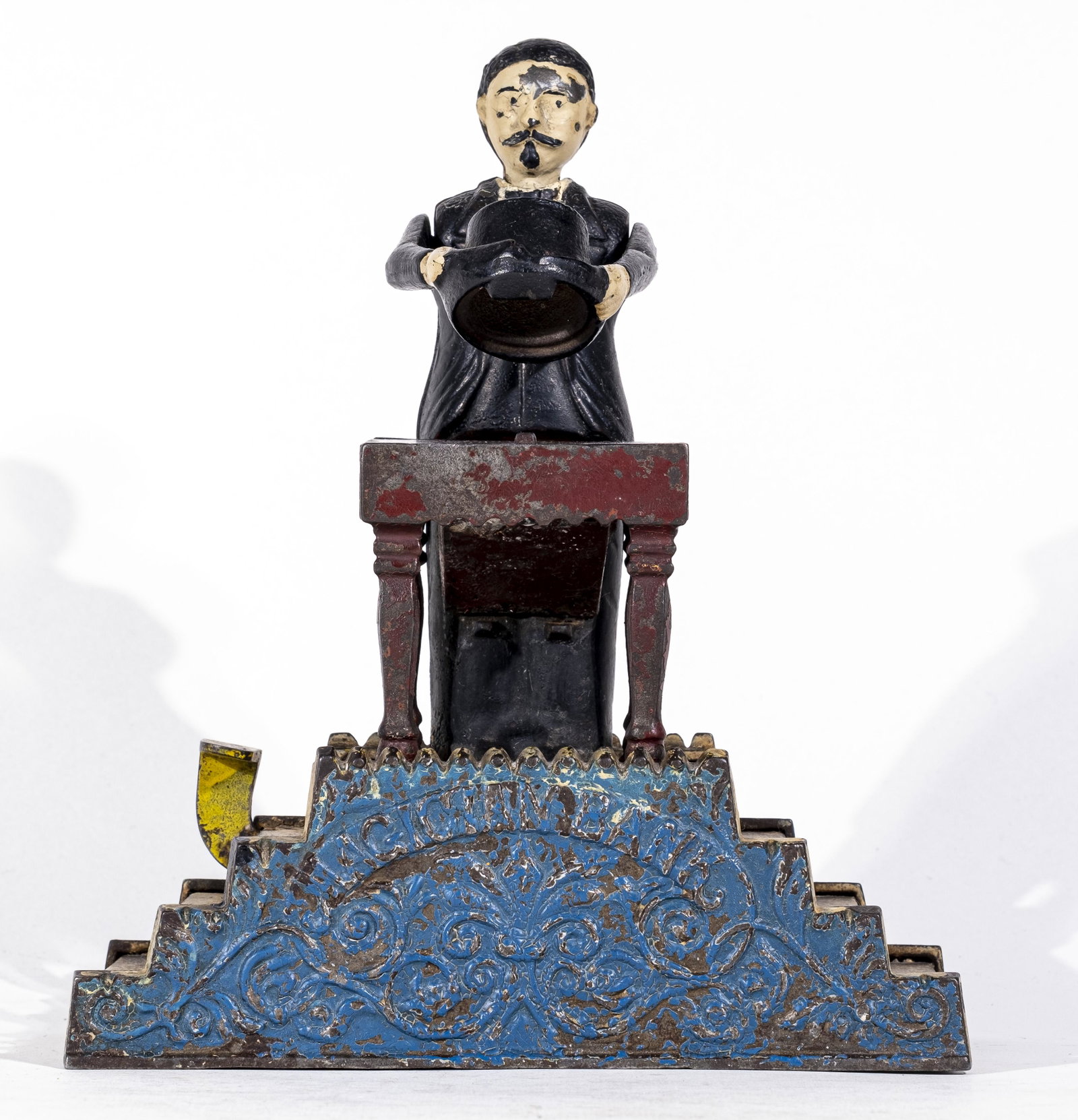 Magician Iron Bank: Made by J. & E. Stevens Company. Cromwell, Ct. - 1890's. Pennies placed on top quickly disappear when he lowers his top hat.