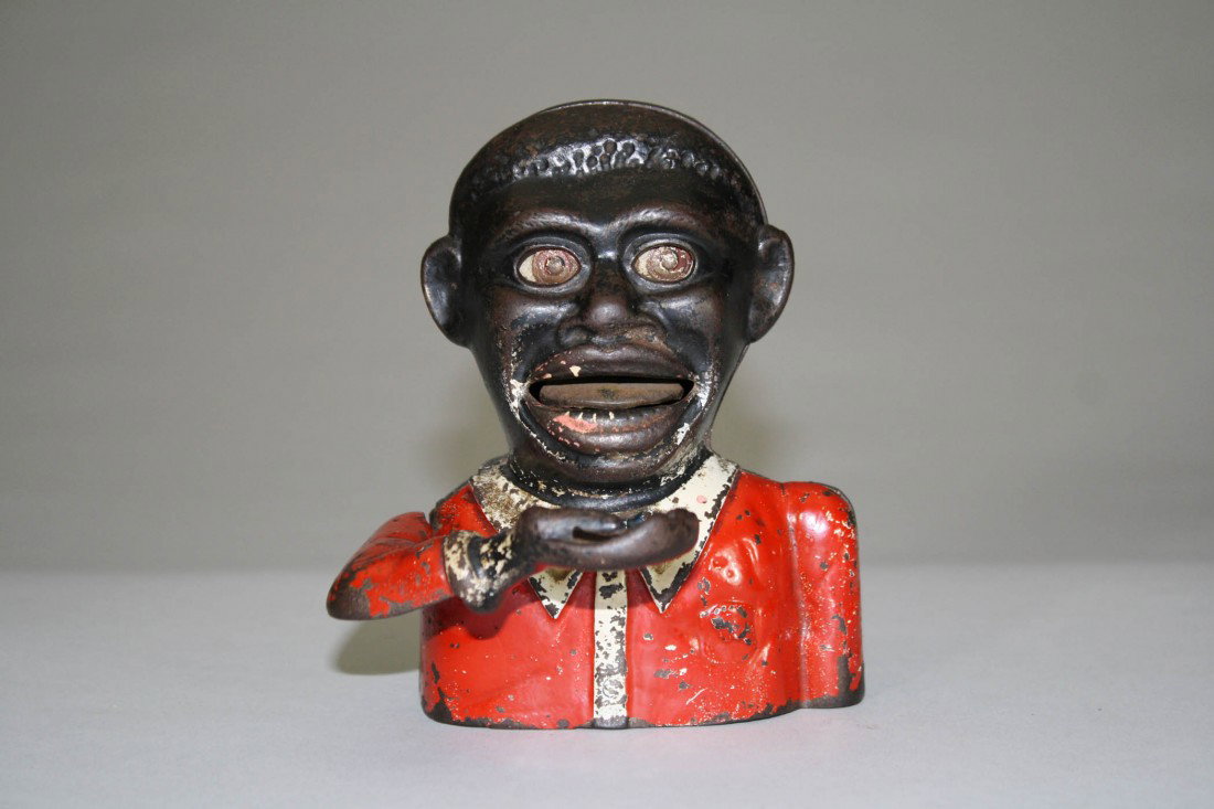 Jolly N., Small, Moving Eyes Mechanical Bank: Sydenham & McOustra • England – Circa 1925 These small sized Jolly N. banks are very scarce. Material: Cast Iron