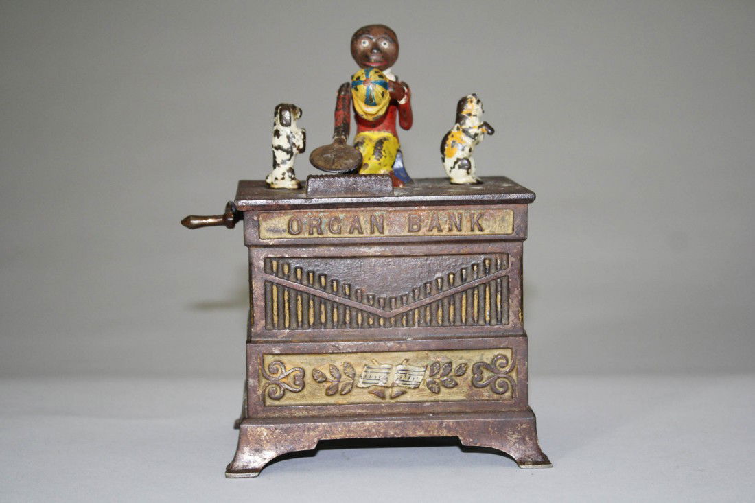 Organ Bank, Cat and Dog Mechanical Bank: Manufactured by Kyser & Rex Company Philadelphia, Pennsylvania – Circa 1882 The monkey doffs his hat in thanks for the penny you have given him. The animals rotate and the bells chime when the crank