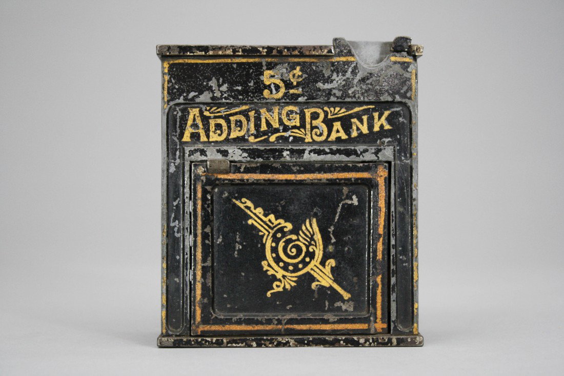 5¢ Adding Bank Mechanical Bank: Designed by Isaac Pforzheimer New York, New York – Circa 1889 Insert coins in the top of the bank, the bank will open when $5 has been registered. This is one of the finest known examples. Material: