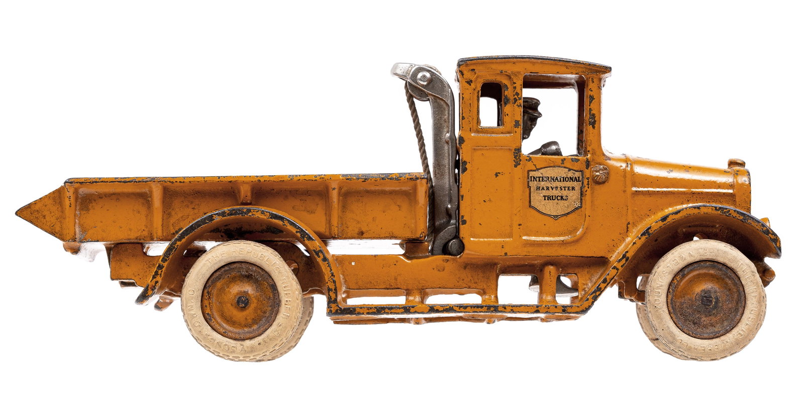 International Harvester Truck - Rare Orange Color Iron Toy: Made by Arcade Mfg. Company. Freeport, IL - 1932 - 10 1/2" Long. This truck is very scarce painted orange.