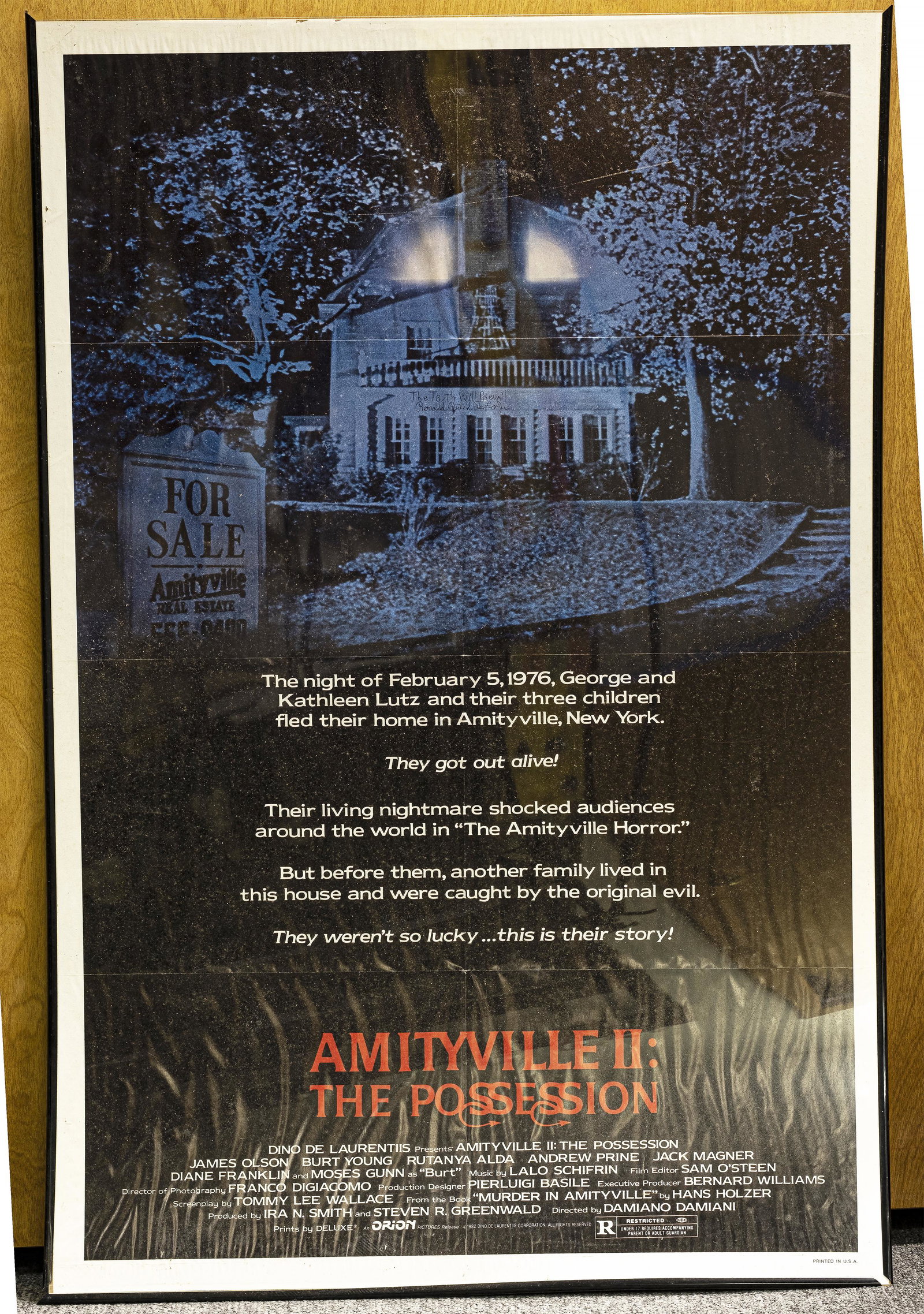 Amityville II: The Possession Poster: Orion Pictures. Copyright 1982. 41" H x 27" W. With the inscription: "The Trust Will Prevail" and signed Ronald Butch DeFeo Jr.