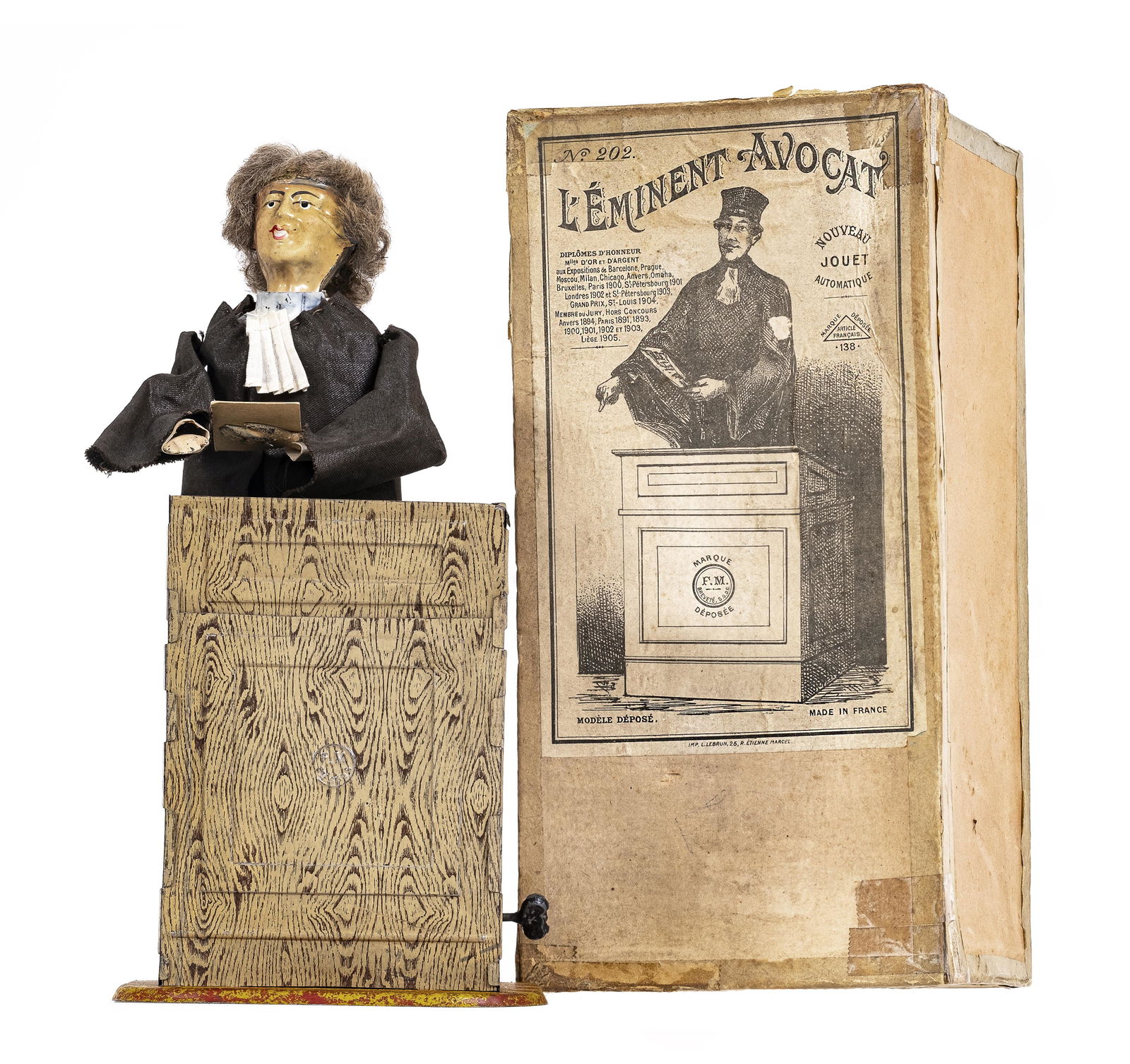 The Eminent Attorney - Tin Windup Toy: Made by Fernand Martin Company. France - Early 1900's - 9 3/4" Tall. The lawyer is seen arguing his case in the courtroom. He's dressed in his robes and he reads from the book of Civil Codes, moving h