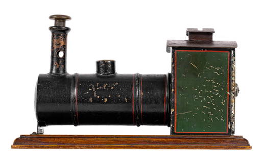 Rare Train Engine Bank and Cigar Cutter: Probably Lutz or Ernst Planck. German - Circa 1880's - 10 1/2" L x 6 3/8" T. We have only seen one other example of this rare, early, German bank. Made of sheet tin mounted to a rectangular wooden bas