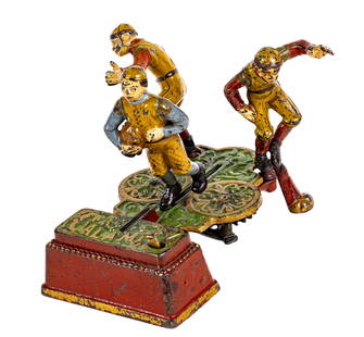 Calamity - Cast Iron Mechanical Bank: Made by J. & E. Stevens Company. Cromwell, Connecticut - Circa 1905. The Calamity Bank portrays collegiate football as it was played at the beginning of the 20th century. In this particular example, w