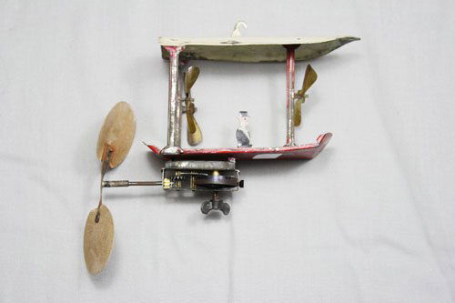 Fantasy Airship German Tin Wind-up: Germany – Circa 1905 This is a scarce early hand painted German windup toy. It is 6” long and works well. Material: Tin and Cardboard