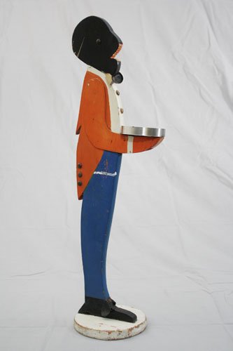 Butler Ash Tray: American – Circa 1930 This snappy guy stands at attention. He is 24” tall. Material: Wood and Tin Provenance: Donal Markey Collection
