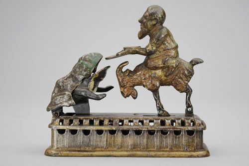 Goat, Frog and Old Man: Made by Mechanical Novelty Works • New Britain, Connecticut – Circa 1885 Also known as the “Initiating Bank – 2nd Degree”. It functions by placing a coin in the man’s tray and then either
